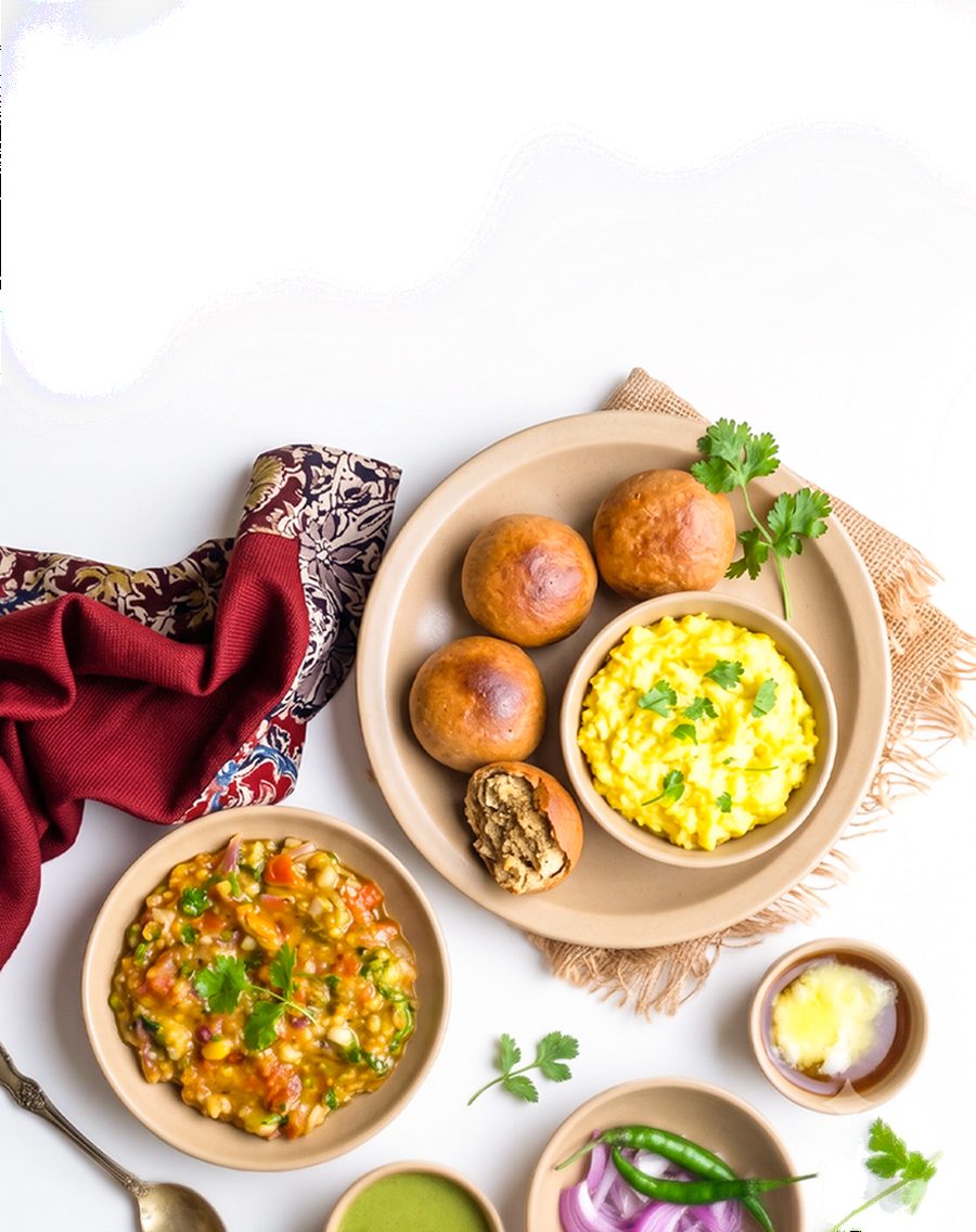 A Litti Chokha spread: roasted littis, dal, chokha, ghee and green chutney